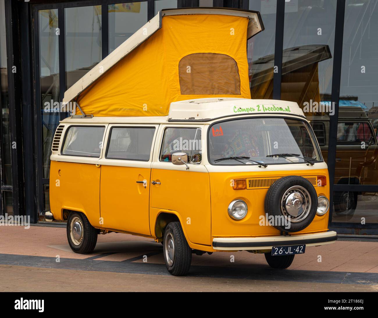 Scheveningen, The Netherlands, 14.05.2023, Classic orange Volkswagen camper van from 1976 with raised roof tent at The Aircooled classic car show Stock Photo