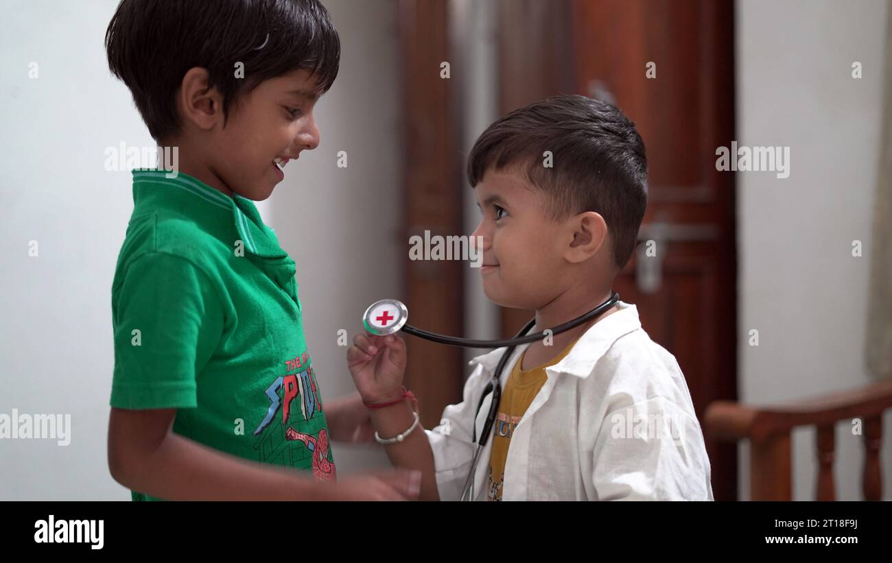 Female doctor or pediatrician with stethoscope listening to heartbeat boy's patient on medical exam at clinic. kid boy on medical examination checkup Stock Photo