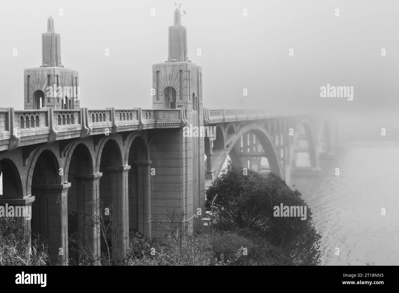 The Isaac Lee Patterson Bridge on US 101 over the mouth of the Rogue River in Gold Beach Oregon on a foggy day in black and white. Stock Photo