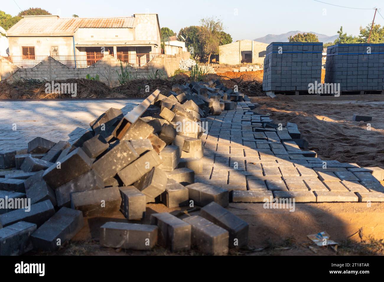 Concrete pavers being used to replace a dirt road Stock Photo