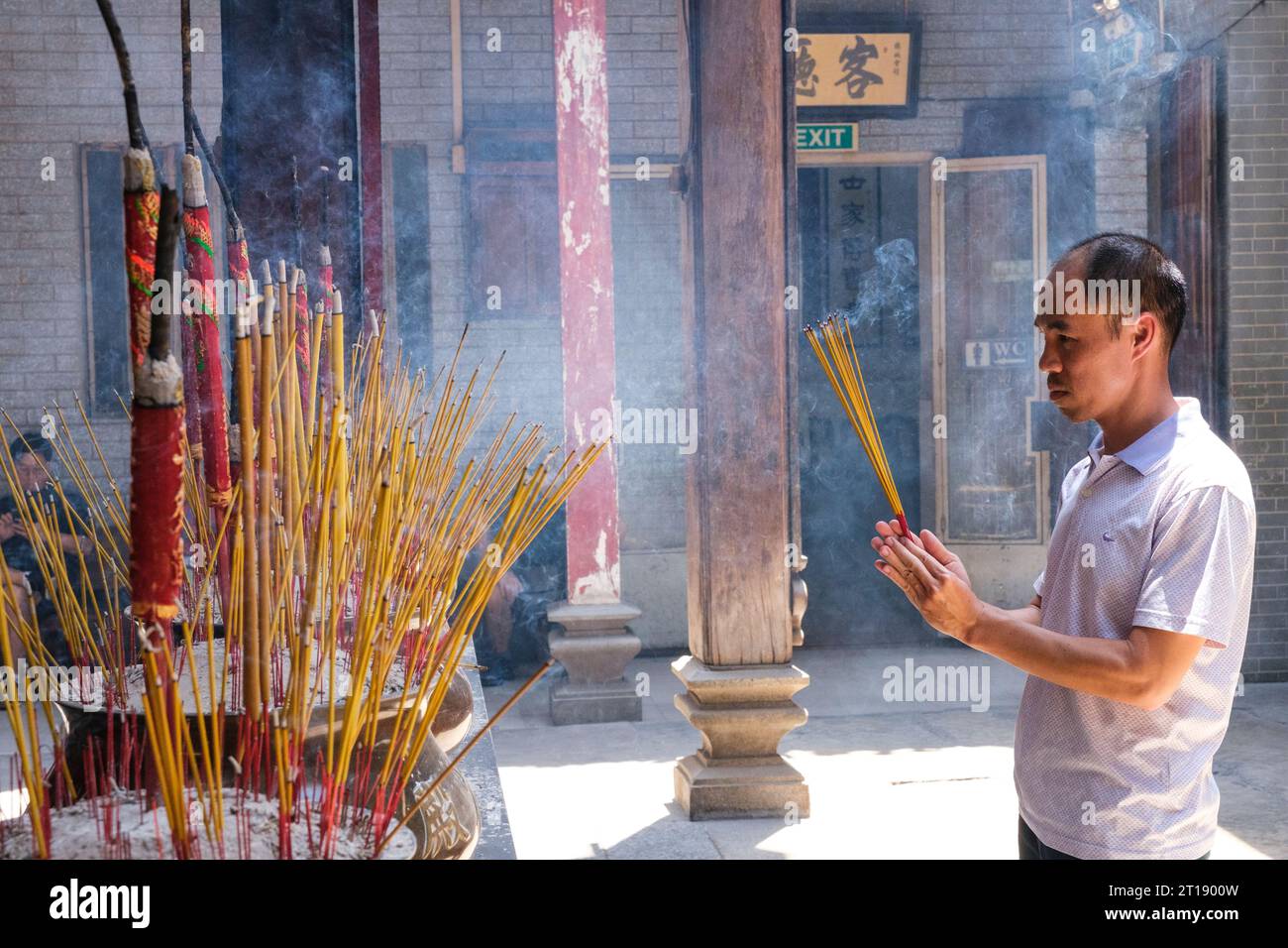 Worshipper Offering Incense before Statue of Lady Thien Hau, Goddess of the Sea, Thien Hau Pagoda, Ho Chi Minh City, Vietnam. Stock Photo