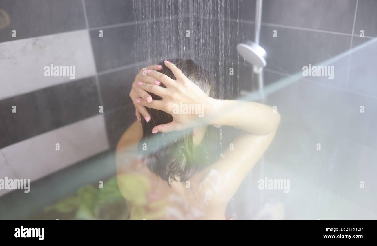 Woman takes hot shower in bathroom closeup Stock Photo Alamy