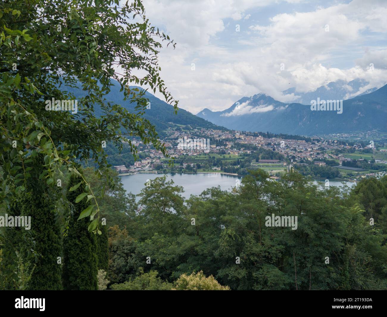 Aerial view of Lake Caldonazzo north of Italy. In the background the trees, Alps, blue sky. Reflection of mountains in water. Autumn season. Multi-col Stock Photo