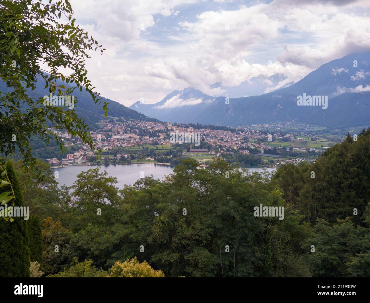 Aerial view of Lake Caldonazzo north of Italy. In the background the trees, Alps, blue sky. Reflection of mountains in water. Autumn season. Multi-col Stock Photo