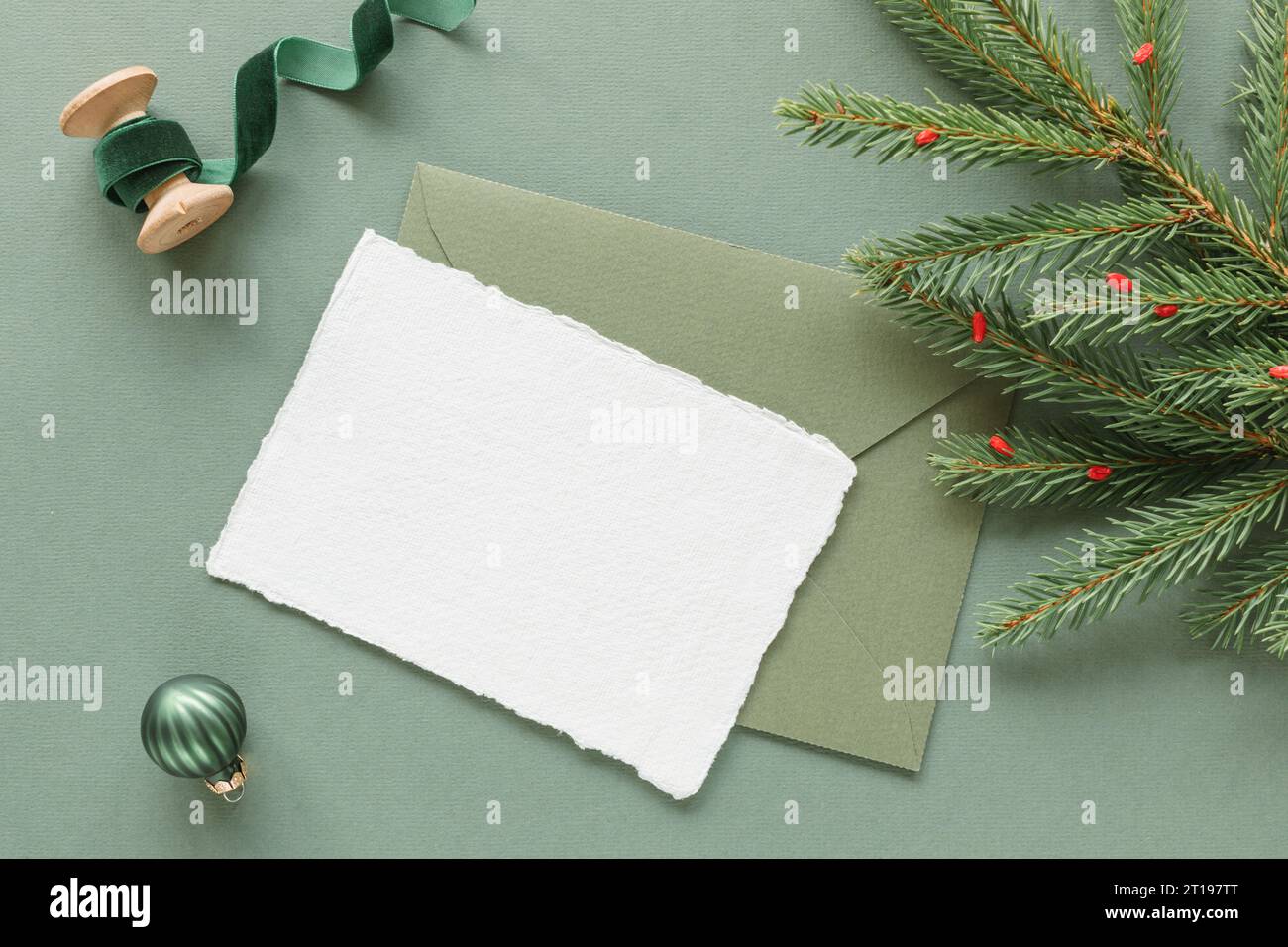 Overhead view of a blank card and envelope with a fir branch, Christmas ...