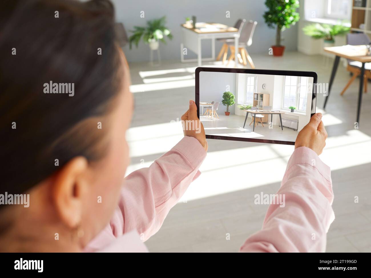 Female real estate agent making virtual tour of office using her ...