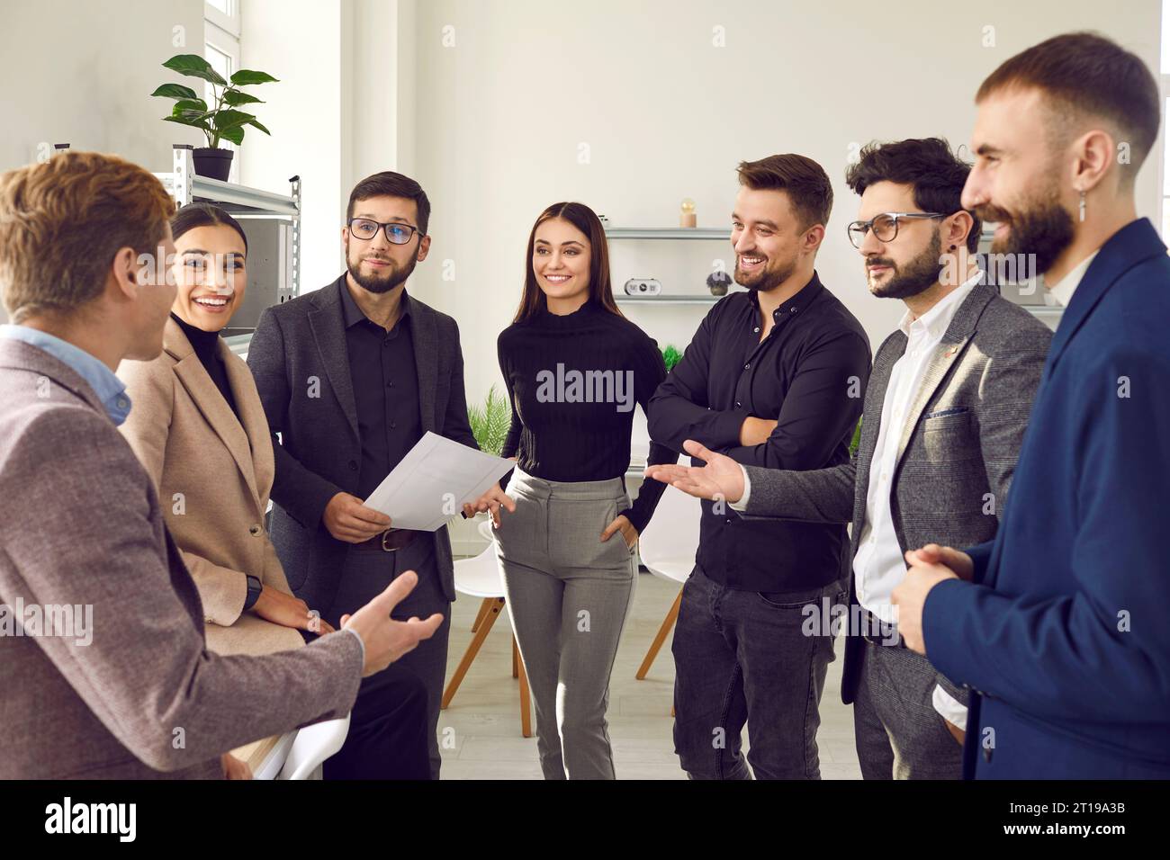 Business people having good conversation standing in circle Stock Photo