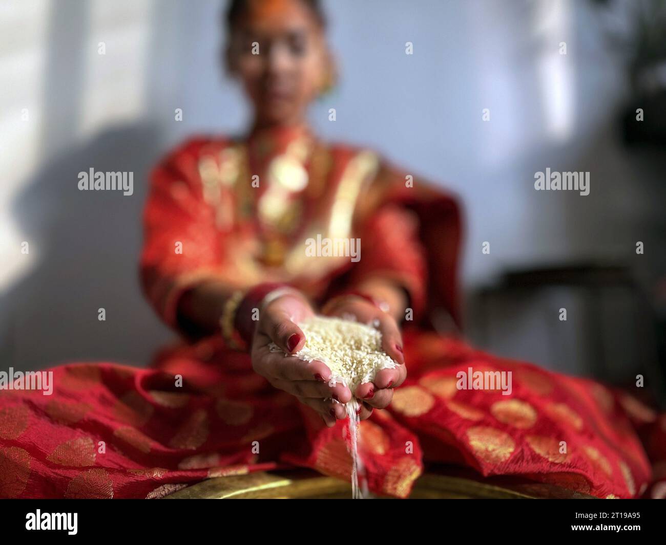 Lalitpur, Bagmati, Nepal. 12th Oct, 2023. A girl from Newar community attends a ritual of ''Barah'', a traditional marriage to the sun in Lalitpur, Nepal on October 12, 2023. Girls from Newar community pass through a tradition of marrying Sun God before puberty by staying inside a room without sunlight for 12 days and then coming out for a meeting in a function symbolizing a celestial marriage ceremony. Girls from Newar community are married thrice in their life, to the bael fruit and the sun before marrying a human. (Credit Image: © Sunil Sharma/ZUMA Press Wire) EDITORIAL USAGE ONLY! Not fo Stock Photo