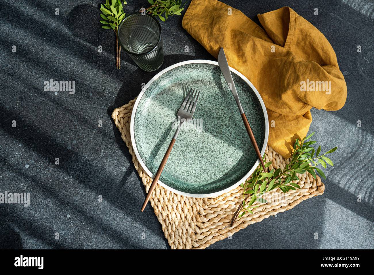 Overhead view of a place setting with fresh pistachio branches Stock Photo