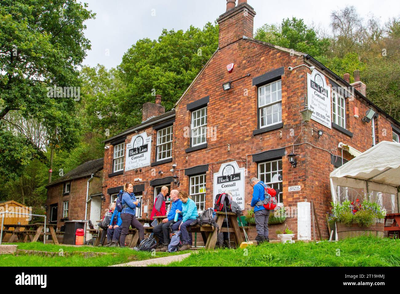 U3A walking group members stopped for a drink at the Black Lion pub at Consall wharf  in the Churnet valley Staffordshire England Stock Photo