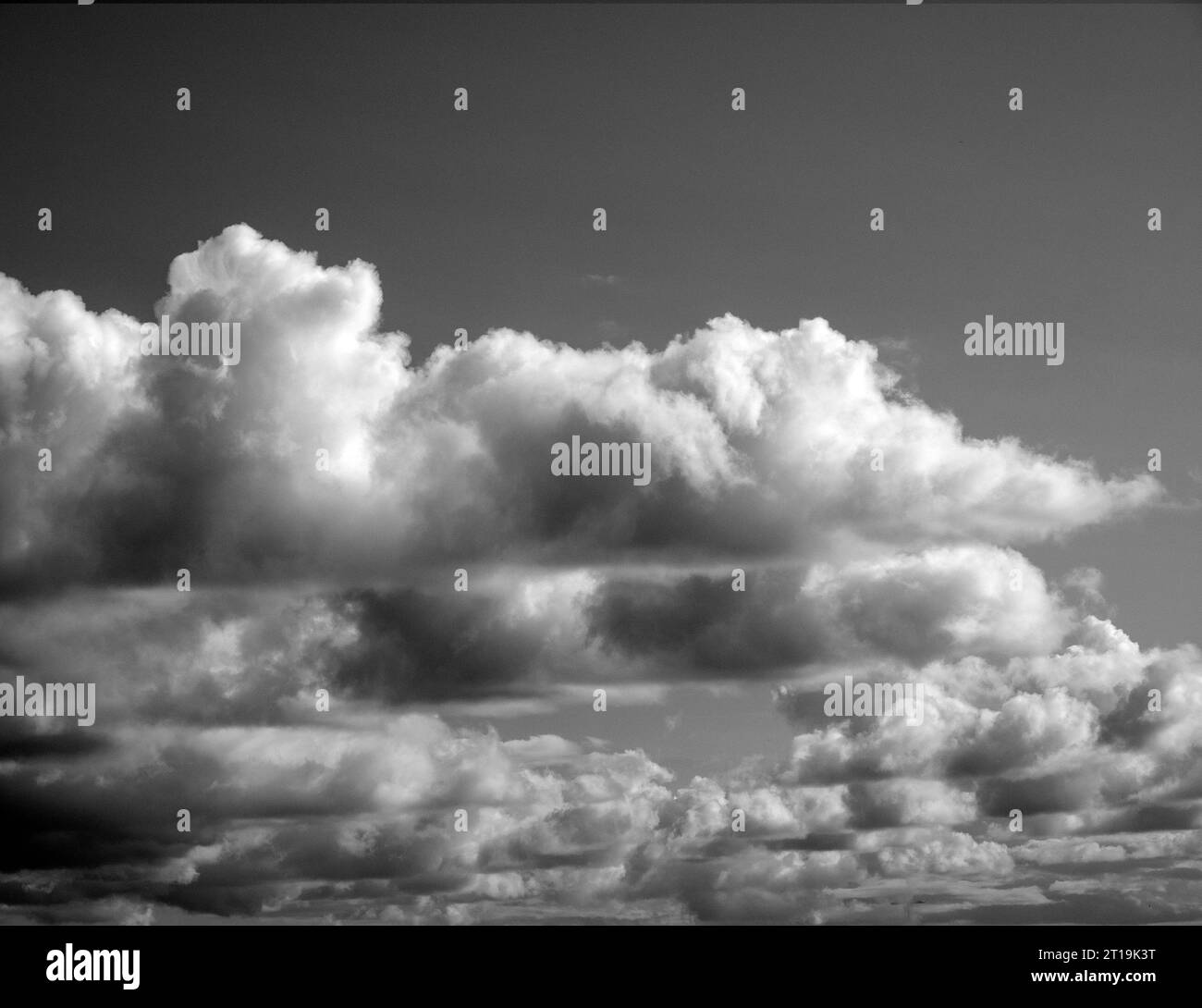 Black and White Beautiful sky with fluffy white clouds over modern city ...