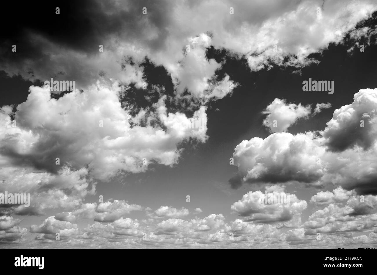 Black and White Beautiful sky with fluffy white clouds over modern city ...