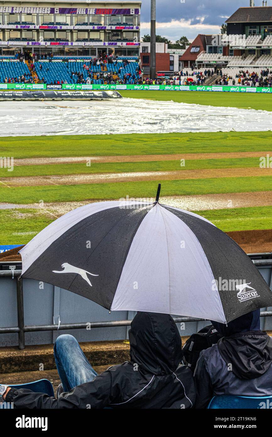 Covers on the pitch and the outfield sodden after a torrential downpour rained off an evening T20 match at Headingley Cricket Ground at Leeds, Yorks. Stock Photo