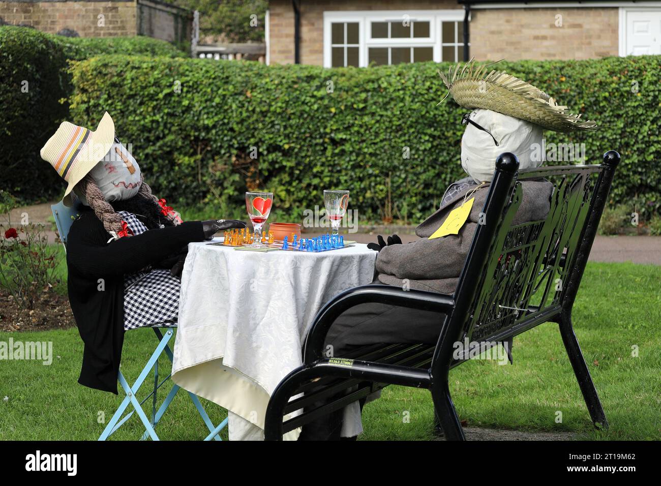 Two scarecrows enjoying a game of chess at village scarecrow festival in Sharnbrook, Bedfordshire, England, UK Stock Photo