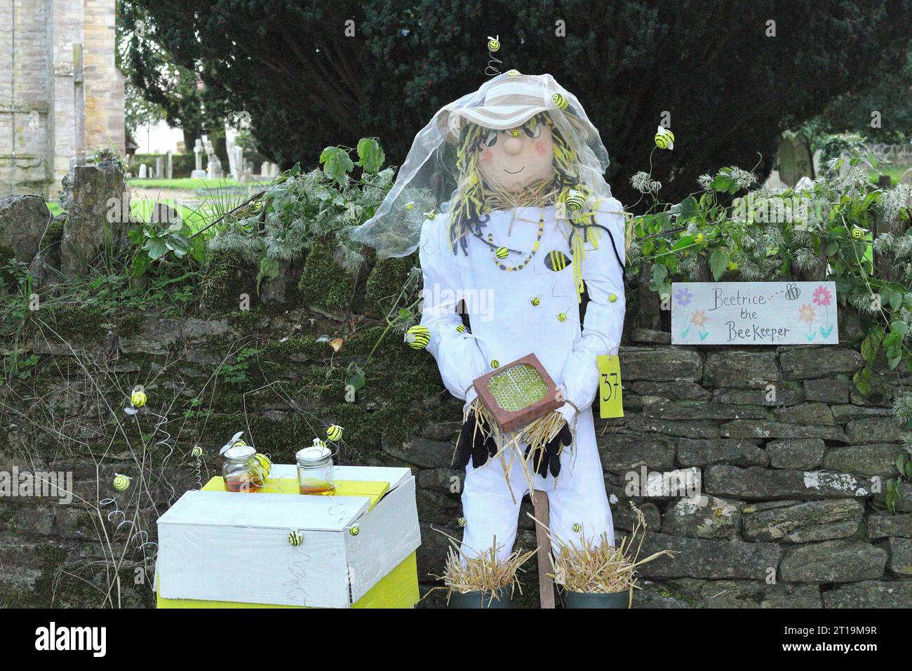 Beekeeper scarecrow with beehive at village scarecrow festival in Sharnbrook, Bedfordshire, England, UK Stock Photo