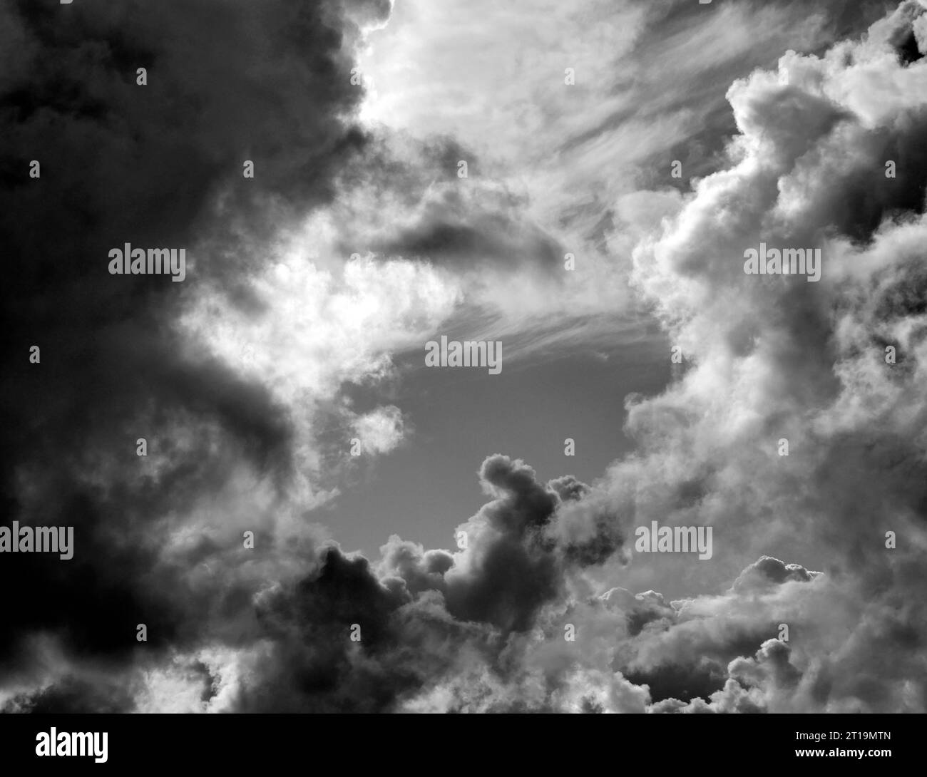 Black and White Beautiful sky with fluffy white clouds over modern city ...