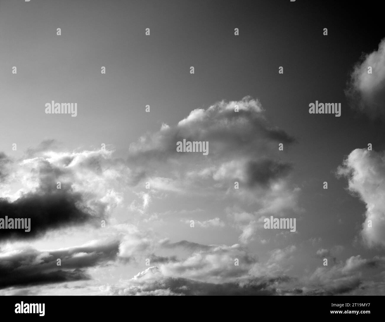 Black and White Beautiful sky with fluffy white clouds over modern city ...