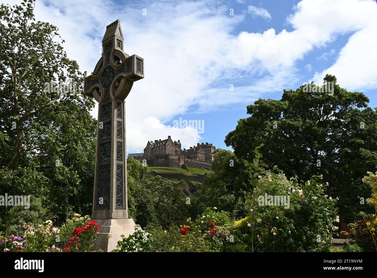 The castle of Edinburgh as seen from Princes street with a celtic cross standing forward, Scotland. Stock Photo