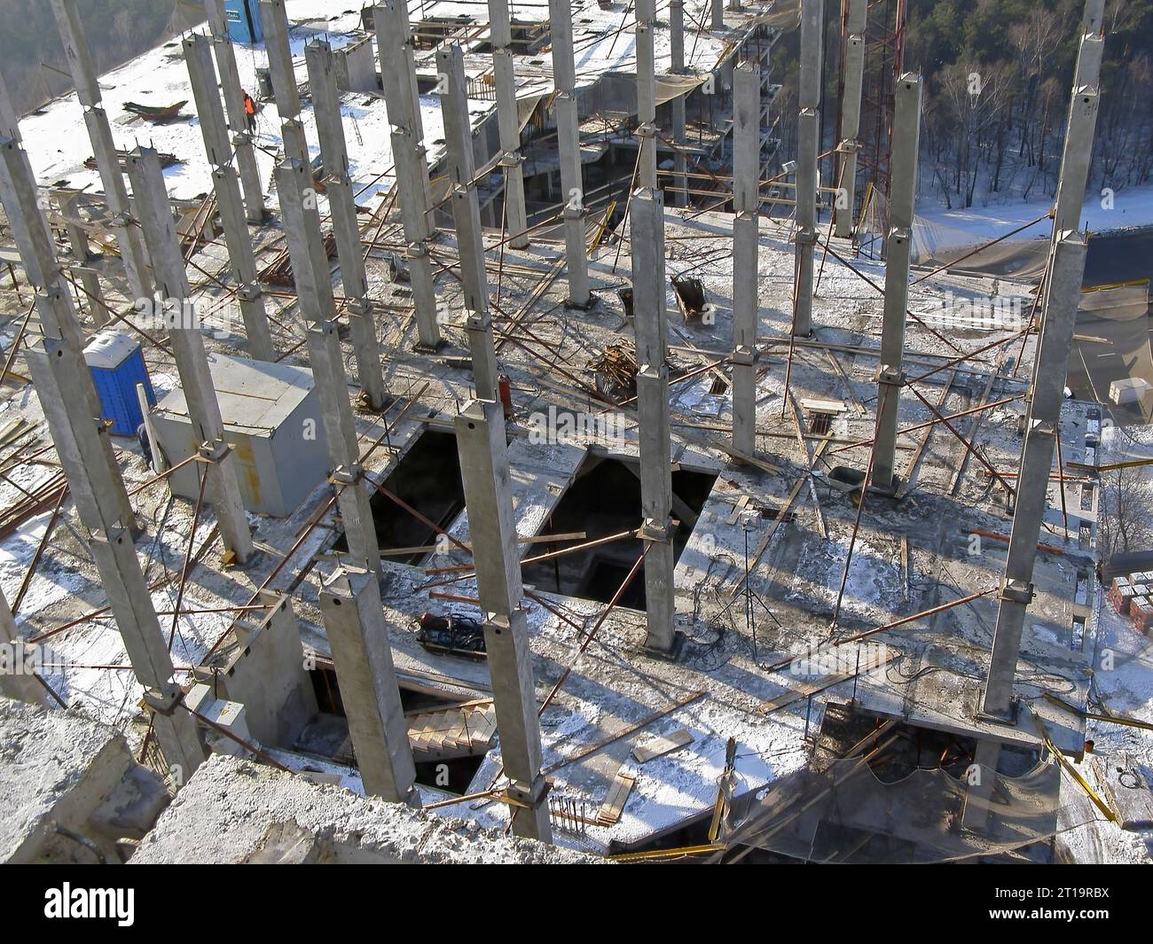 Precast reinforced concrete elements of the building, view from above. A frame made of columns and slabs on a construction site Stock Photo
