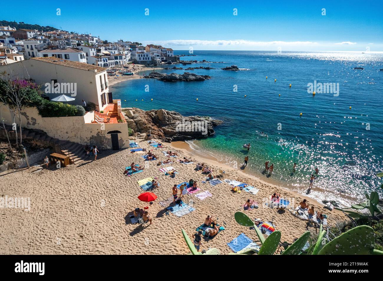 sunbathers om nne of the beaches of Calella de Palafrugel with its golden sand and moderate waves Stock Photo