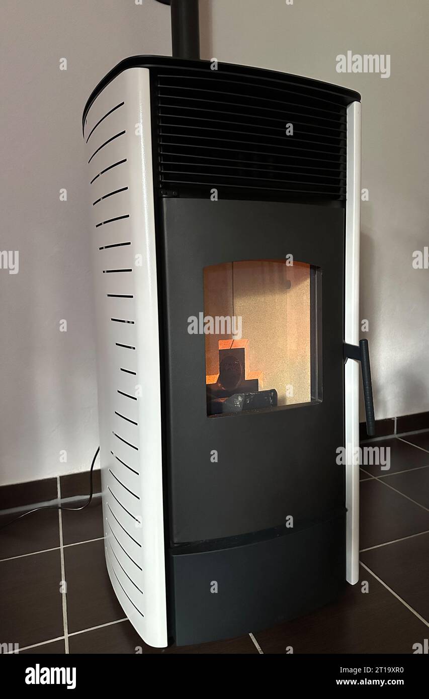 Pellet stove oven fireplace with pellets renewable energy Stock Photo