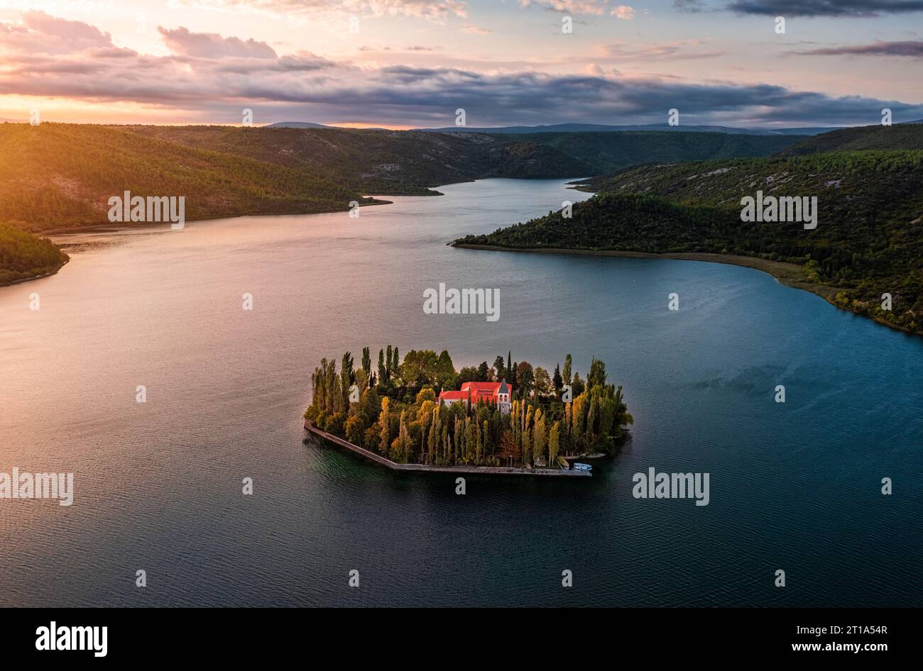 Visovac, Croatia - Aerial panoramic view of Visovac Christian monastery in Krka National Park on a bright autumn morning with dramatic golden sunrise Stock Photo