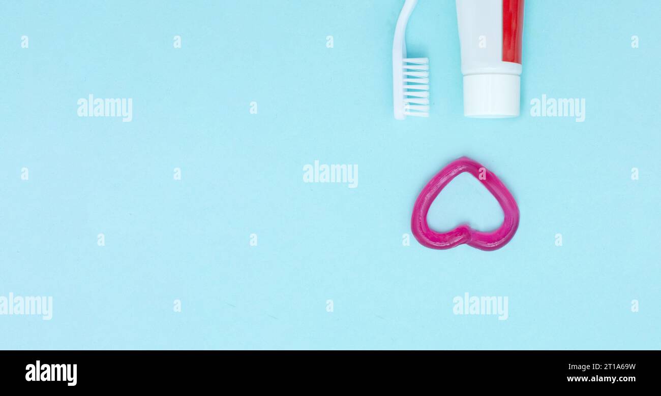 Toothpaste Theme Closeup of a toothpaste, toothbrush and toothpaste heart on blurred ...