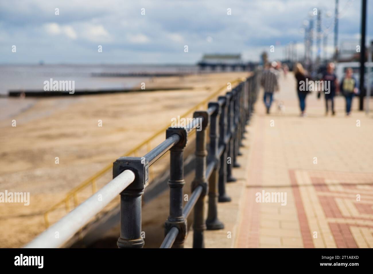 Very shallow focus or depth of field with out of focus people walking on the prom at Cleethorpes Stock Photo