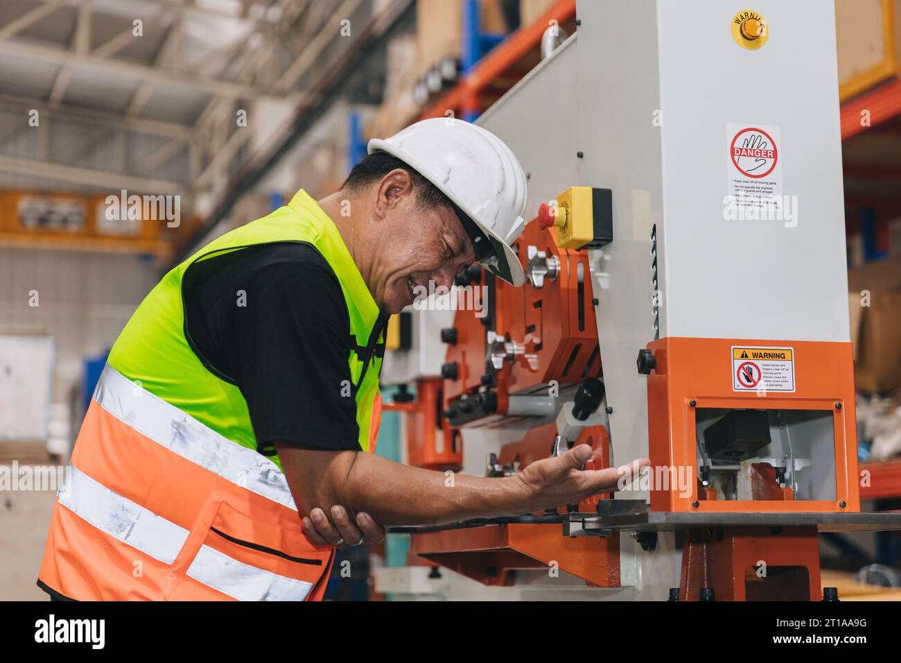 Senior male worker serious accident machine hand clamp injury in industry workplace need emergency medical help Stock Photo