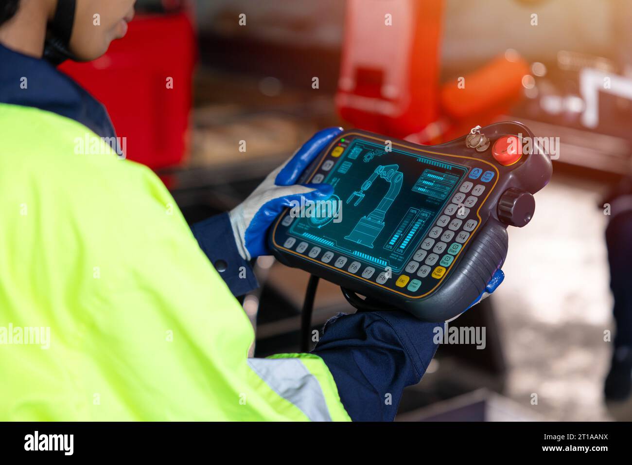 Smart engineer staff worker use digital remote control operate industry robot arm in automation factory technology engineering Stock Photo