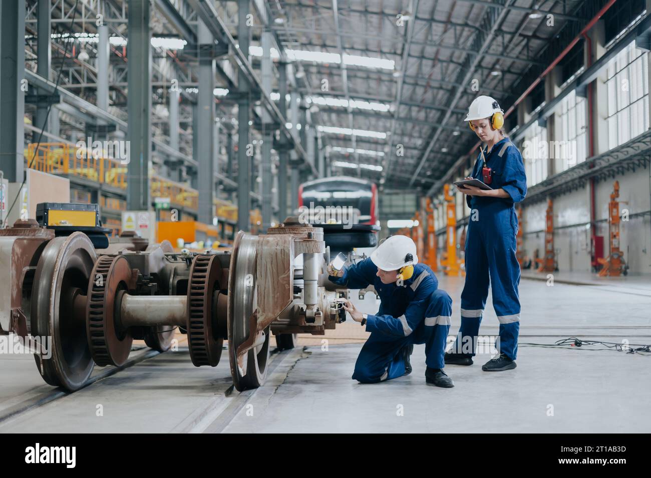Professional electricity train rail engineer worker working train service inspector checking track rail system in train depot workshop Stock Photo