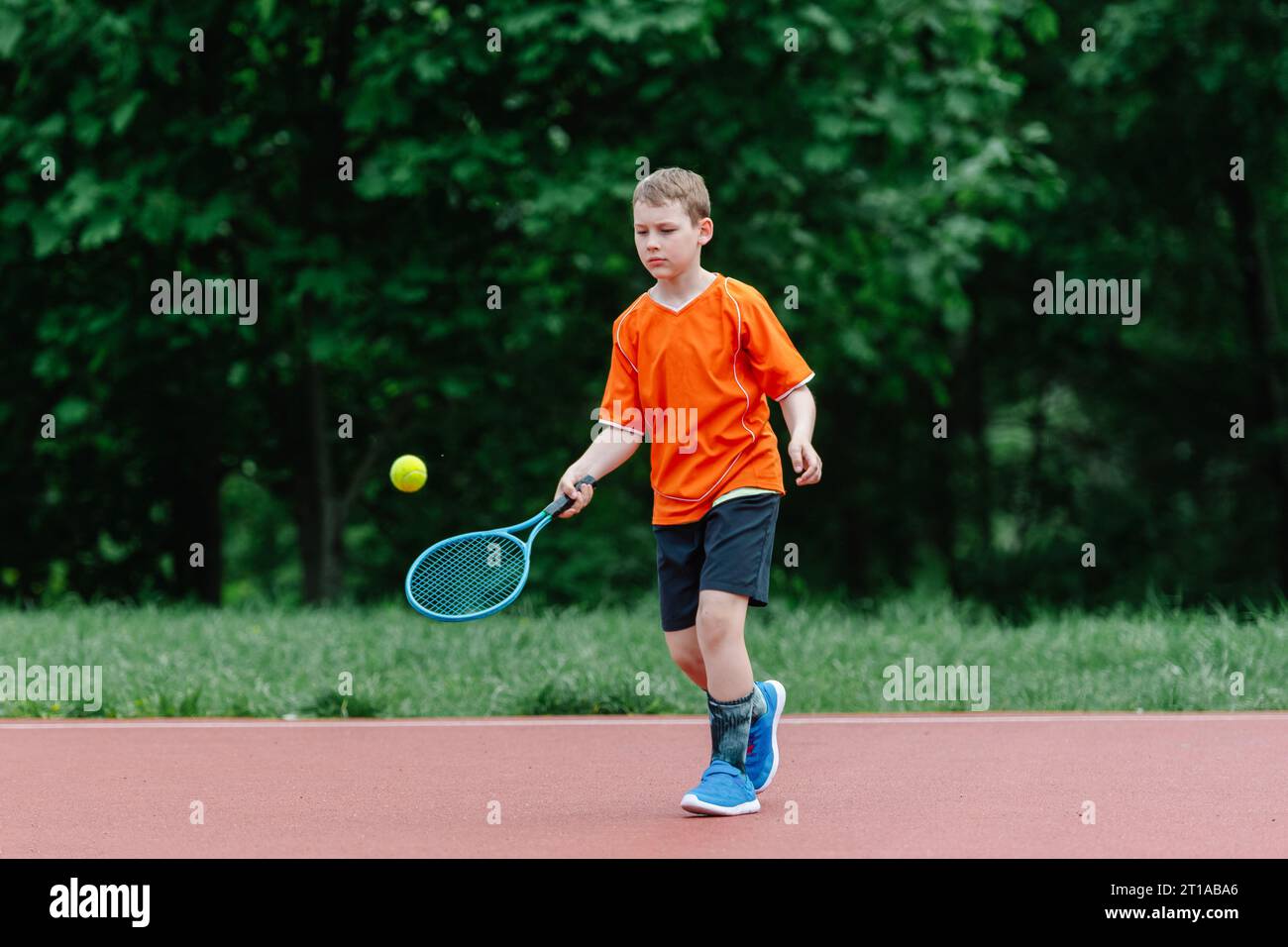 Kids With Rackets Child with tennis racket on tennis court. Training for young kid ...