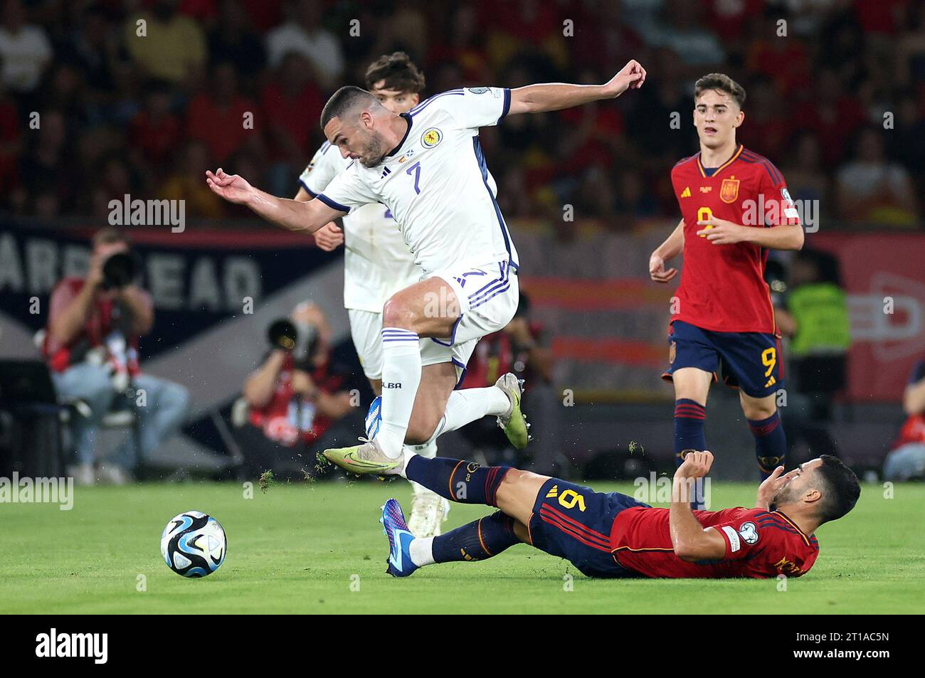 Scotland's John McGinn (left) and Spain's Mikel Merino battle for the ball during the UEFA Euro 2024 Qualifying Group D match at the Estadio La Cartuja de Sevilla in Seville, Spain. Picture date: Thursday October 12, 2023. Stock Photo