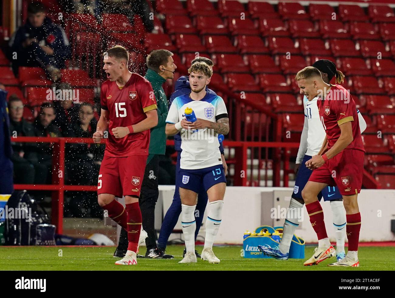 Nottingham, UK. 12th Oct, 2023. Harvey Elliot squirts a water bottle over Luka Subotic after they celebrated the first goal with the their bench during the UEFA European Under-21 Championship Qualifier match at the City Ground, Nottingham. Picture credit should read: Andrew Yates/Sportimage Credit: Sportimage Ltd/Alamy Live News Stock Photo