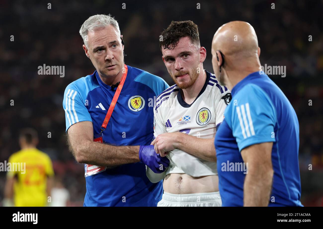 Scotland's Andrew Robertson is helped from the pitch after picking up an arm injury during the UEFA Euro 2024 Qualifying Group D match at the Estadio La Cartuja de Sevilla in Seville, Spain. Picture date: Thursday October 12, 2023. Stock Photo