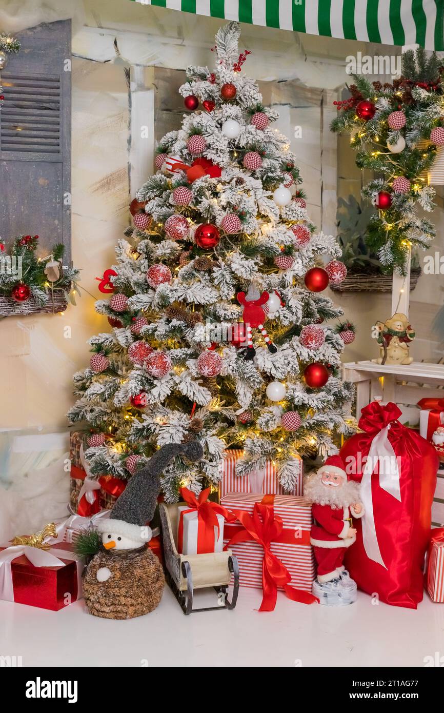 Christmas decorations. Christmas background. Beautiful holiday decorated room with Christmas tree with presents under it Stock Photo
