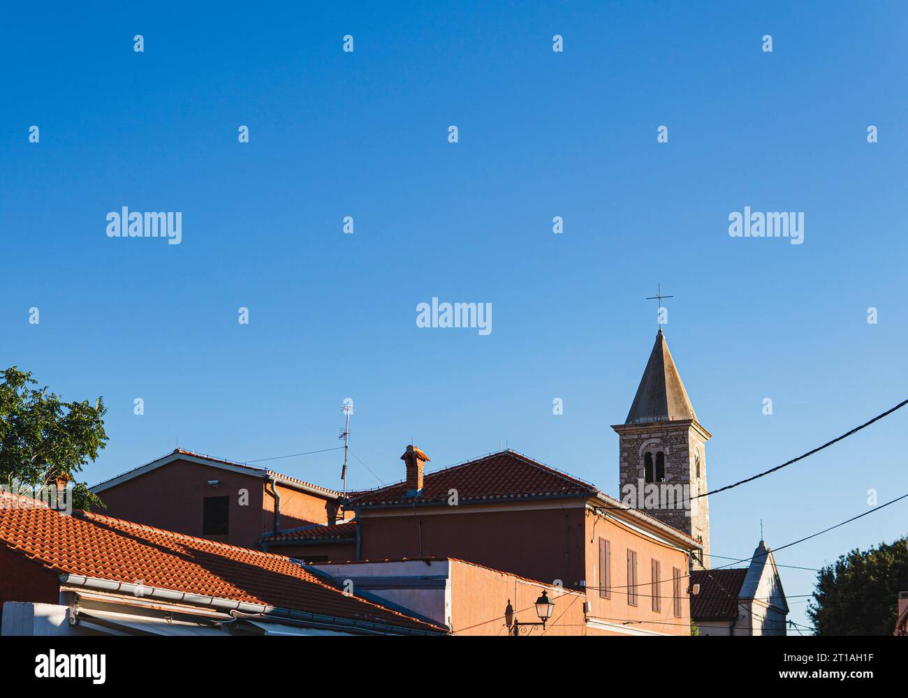 rooftops with tower of medieval church build from stone in the city of Nin in Croatia Stock Photo