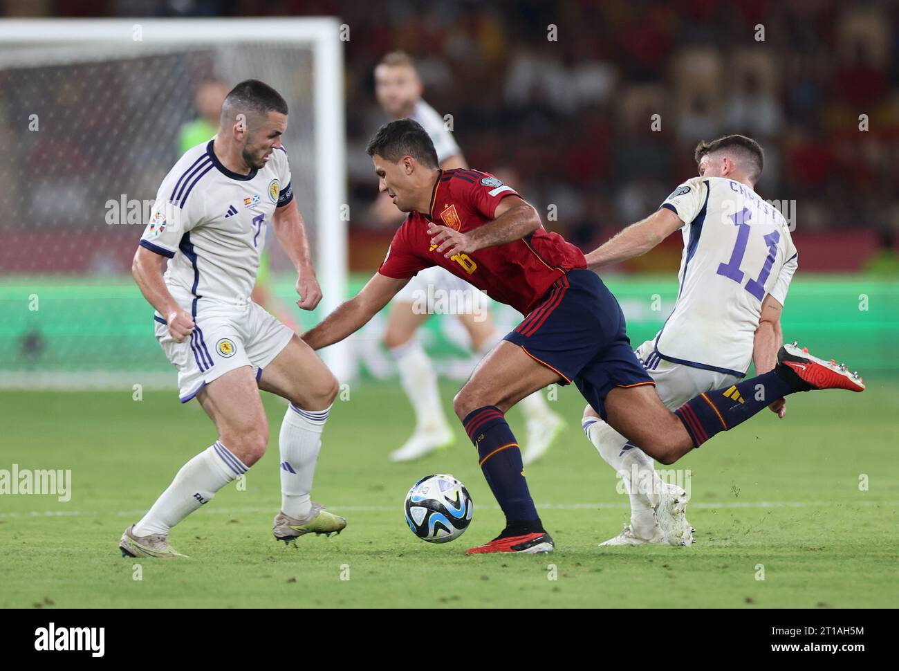 Scotland's John McGinn (left) and Spain's Rodri battle for the ball during the UEFA Euro 2024 Qualifying Group D match at the Estadio La Cartuja de Sevilla in Seville, Spain. Picture date: Thursday October 12, 2023. Stock Photo