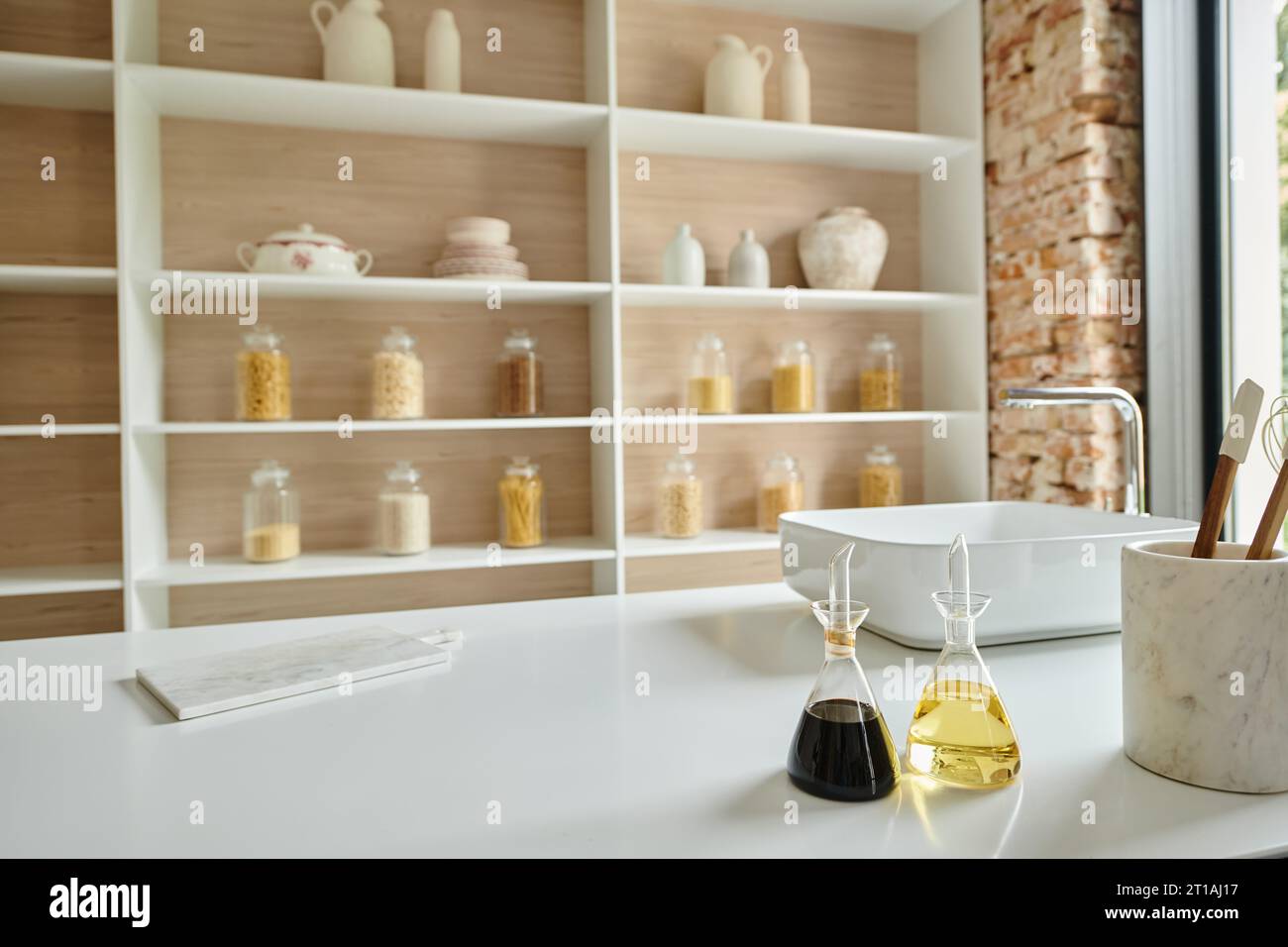 stylish interior of modern kitchen, glass bottles with balsamic vinegar