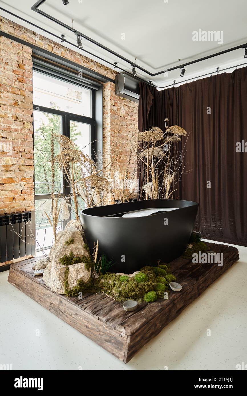 black bathtub inside of modern apartment with panoramic windows and