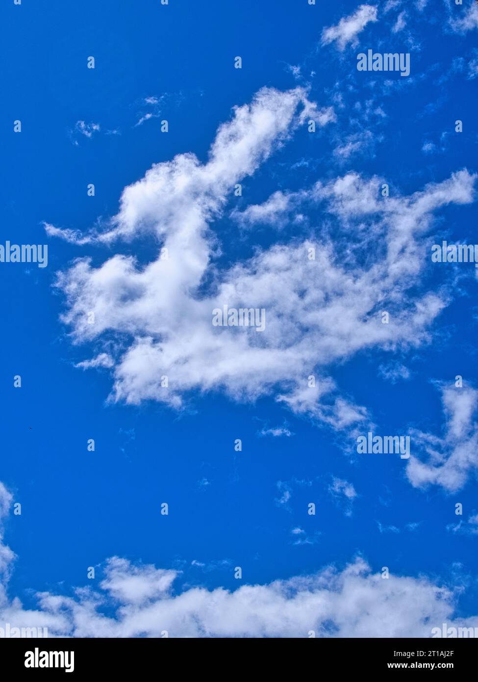 Beautiful spread out cottony clouds in intense blue sky. Sunny weather in Hawaii. Stock Photo
