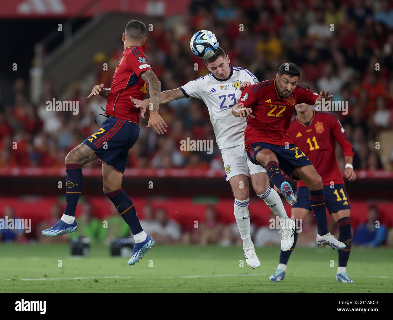 Scotland's Kenny McLean (centre) battles with Spain's Joselu (left) and Jesus Navas during the UEFA Euro 2024 Qualifying Group D match at the Estadio La Cartuja de Sevilla in Seville, Spain. Picture date: Thursday October 12, 2023. Stock Photo