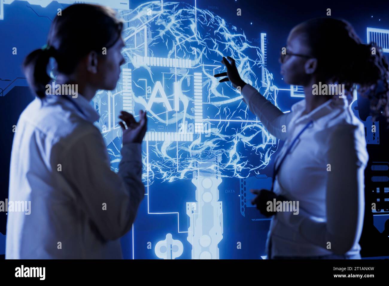 Qualified technicians brainstorm ways to use AI cognitive computing to extract usable information from complex data. Team of specialists implement artificial intelligence to process massive datasets Stock Photo