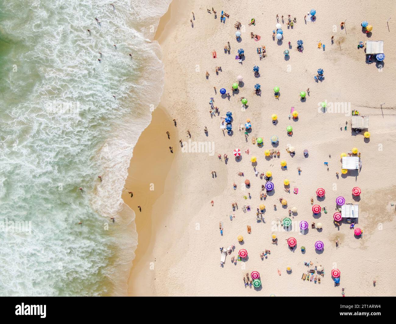 Top down aerial view of people relaxing and enjoying summer at Ipanema Beach in Rio de Janeiro, Brazil. Stock Photo