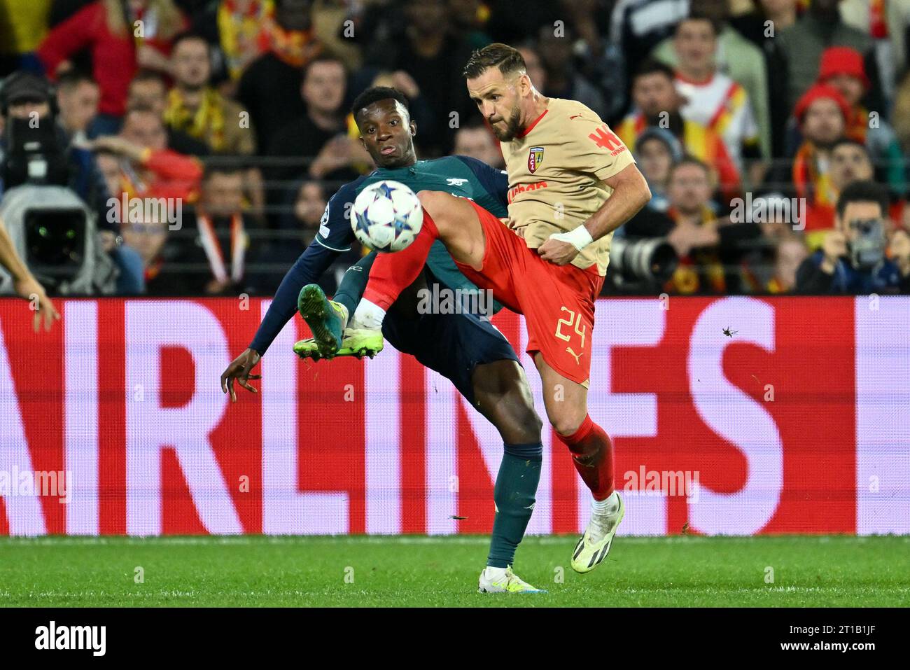 Eddie Nketiah (14) of Arsenal fighting for the ball with Jonathan Gradit (24) of RC Lens during the Uefa Champions League matchday 2 game in group B in the 2023-2024 season between Racing Club de Lens and Arsenal FC on October 3 , 2023 in Lens, France. (Photo by David Catry / Sportpix ) Stock Photo