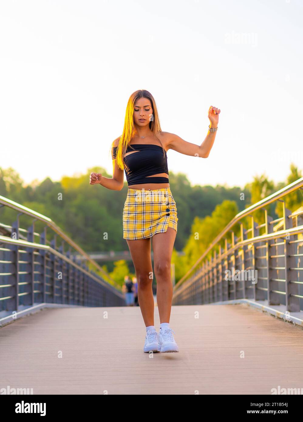 Woman yellow top black skirt hi res stock photography and images Alamy