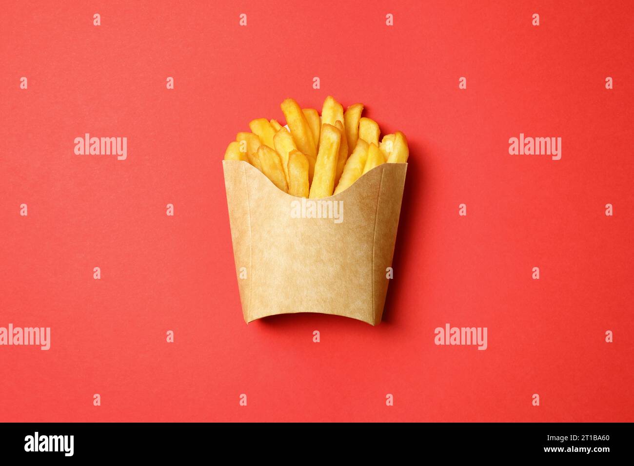 Paper cup with French fries on red table, top view Stock Photo - Alamy