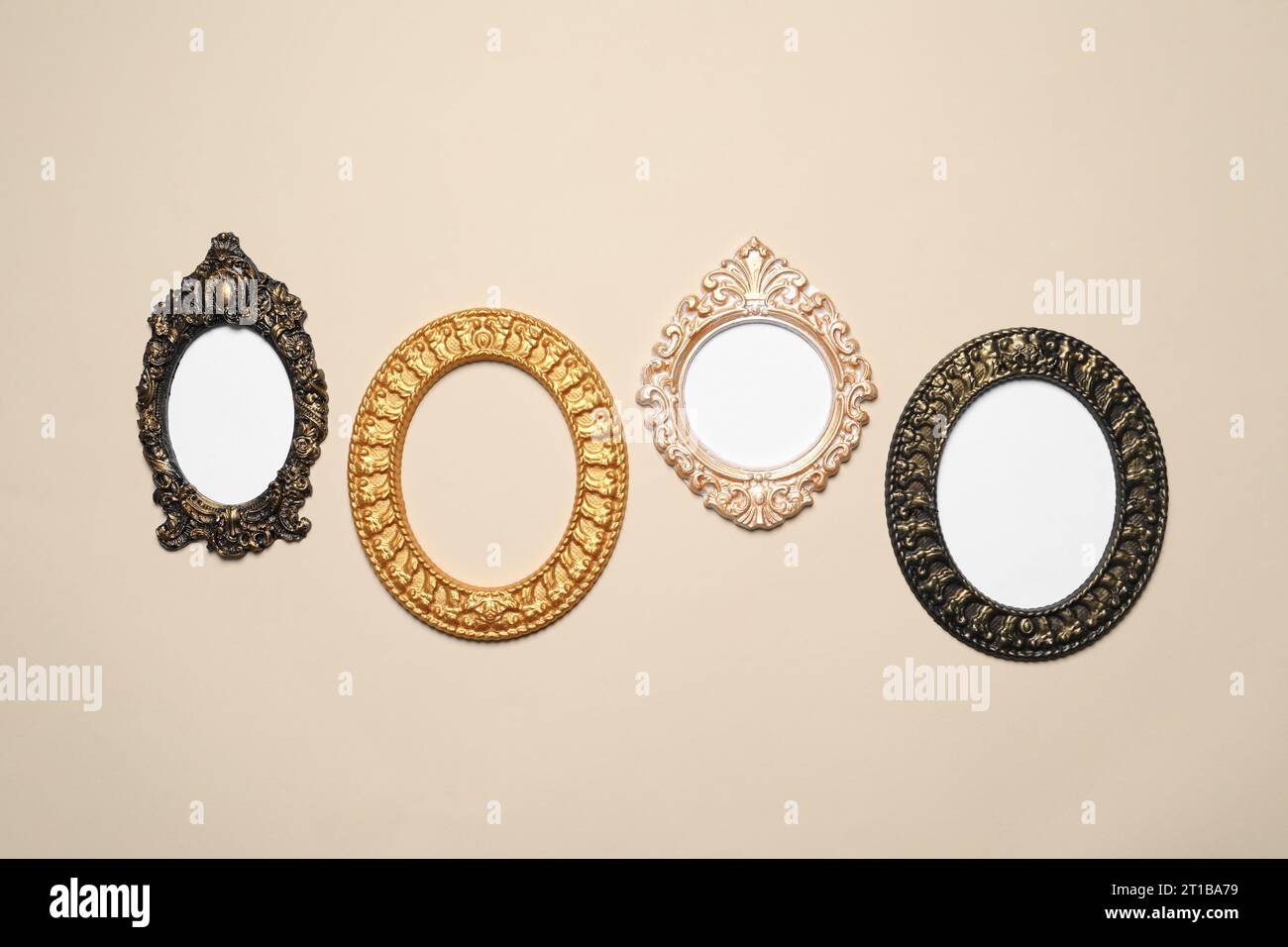 Empty vintage frames hanging on beige wall Stock Photo - Alamy