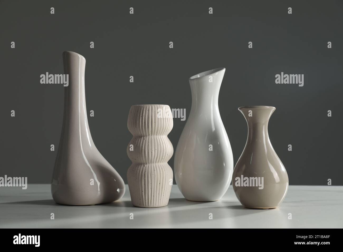 Different stylish vases on white marble table Stock Photo