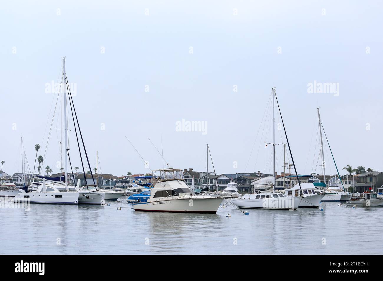 Boats and yachts on the coastline of Newport Beach, California on an overcast afternoon Stock Photo
